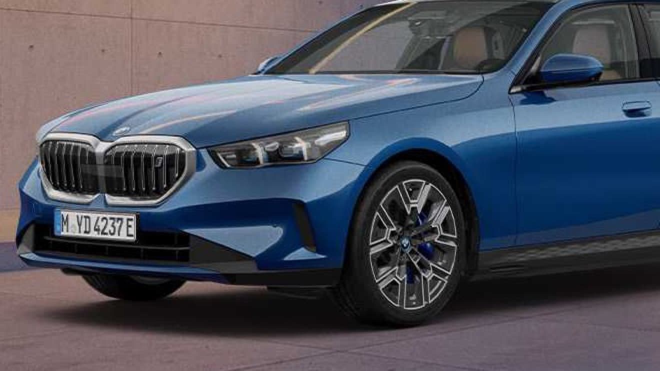 파이토닉 블루 BMW i5 에디션의 앞모습 확대, 키드니 그릴과 20인치 바이컬러 휠 안쪽의 파란 브레이크 캘리퍼
